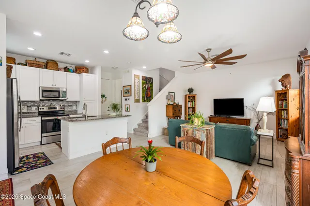 a kitchen with stainless steel appliances kitchen island granite countertop a stove and a sink