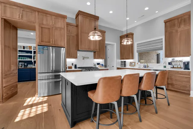 a kitchen with a stove kitchen island furniture and a flat screen tv