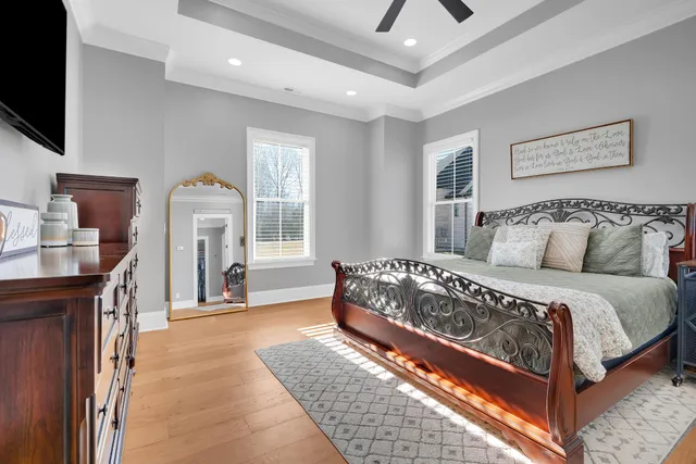 a bedroom with furniture and a flat screen tv