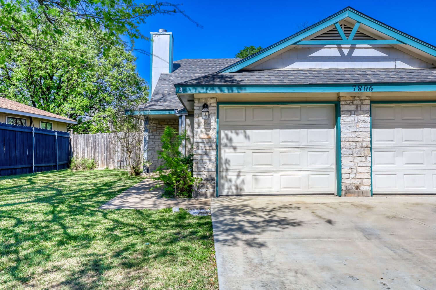 7806 Chimayo Cove, Unit B Austin, TX 78729 - Photo 1 of 11 a front view of a house with garden