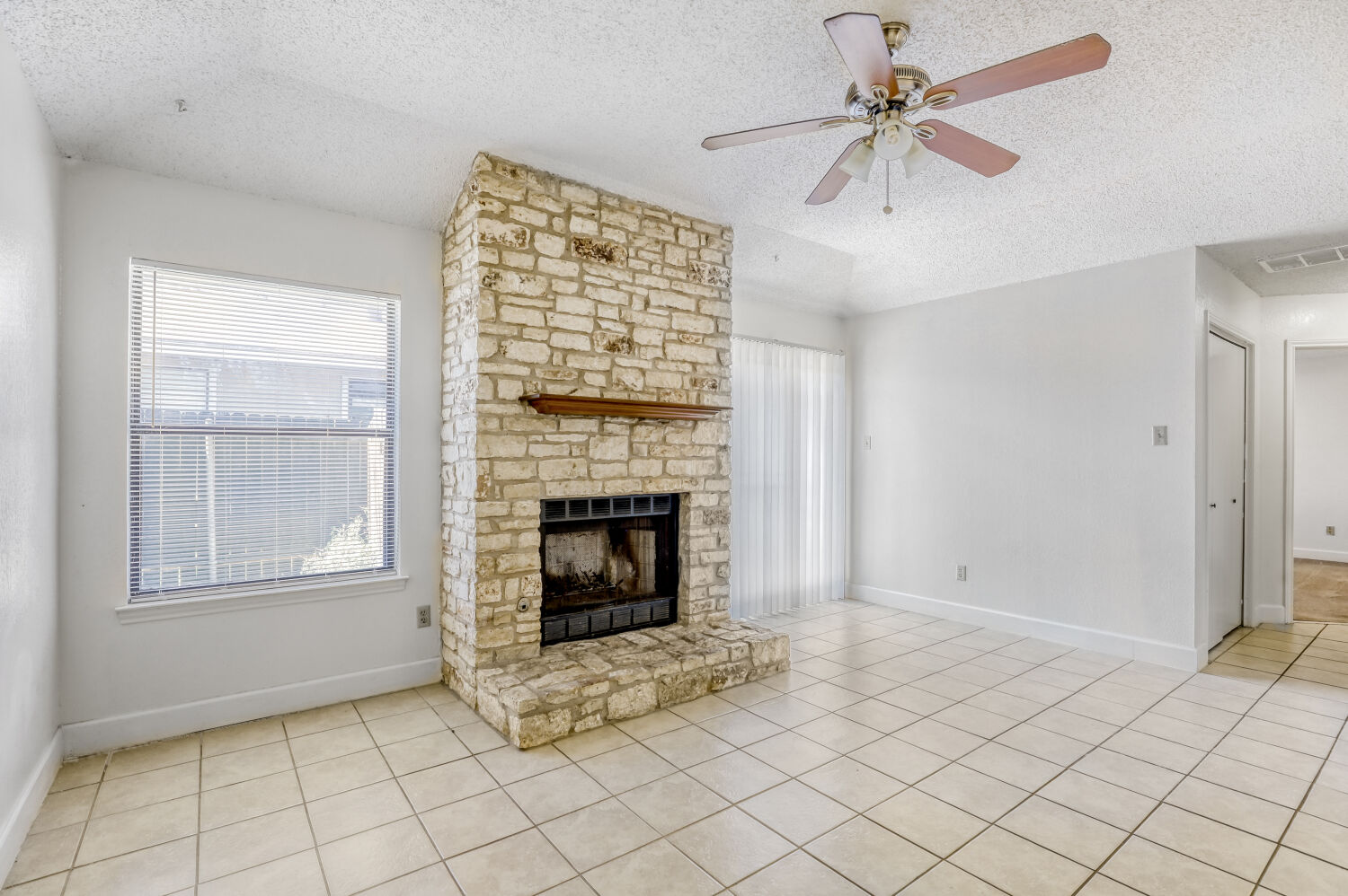 7806 Chimayo Cove, Unit B Austin, TX 78729 - Photo 3 of 11 a view of an empty room with a fireplace
