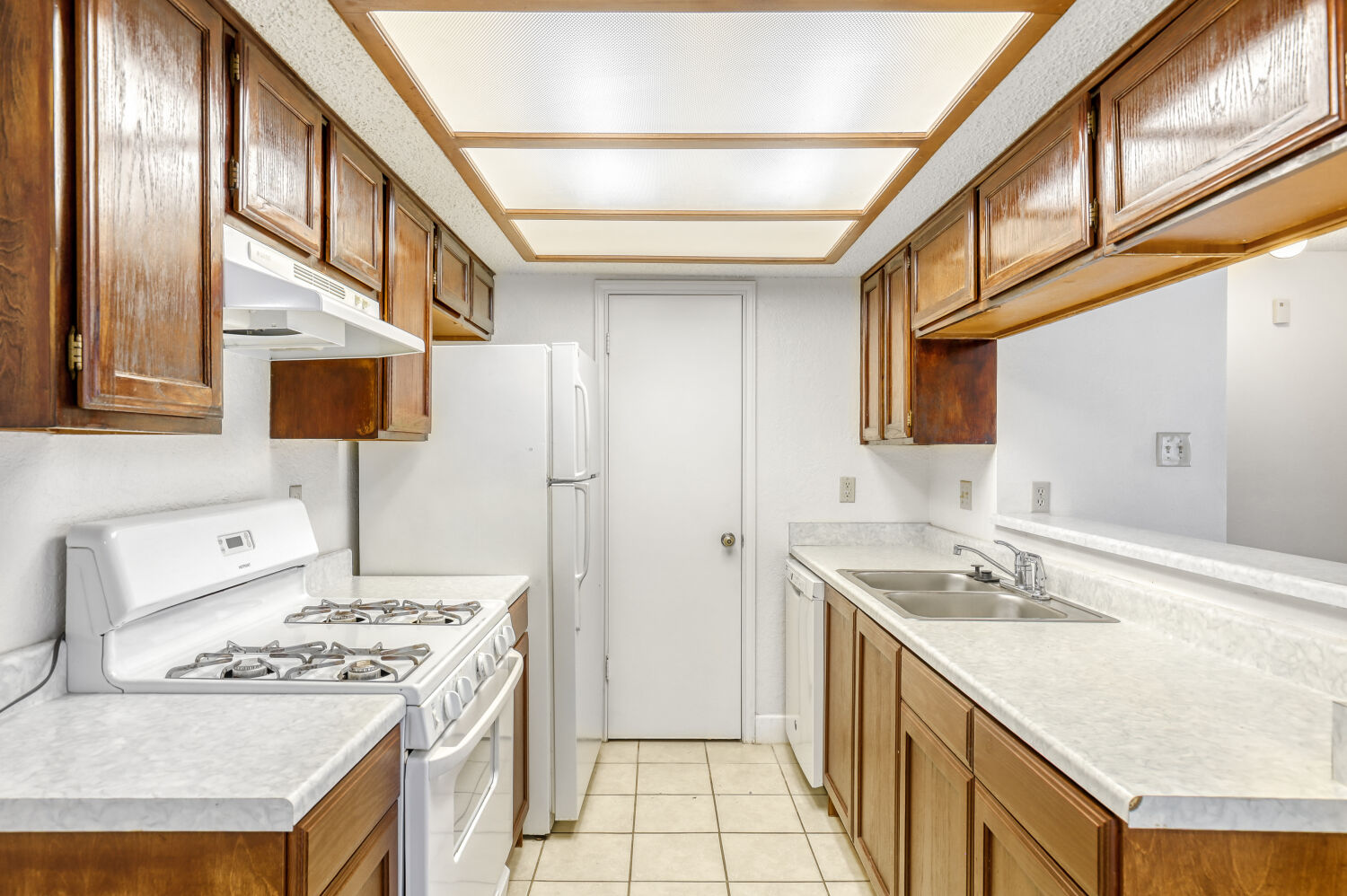 7806 Chimayo Cove, Unit B Austin, TX 78729 - Photo 5 of 11 a kitchen with a stove and a sink