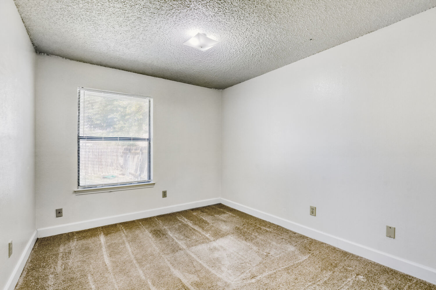 7806 Chimayo Cove, Unit B Austin, TX 78729 - Photo 8 of 11 an empty room with a window