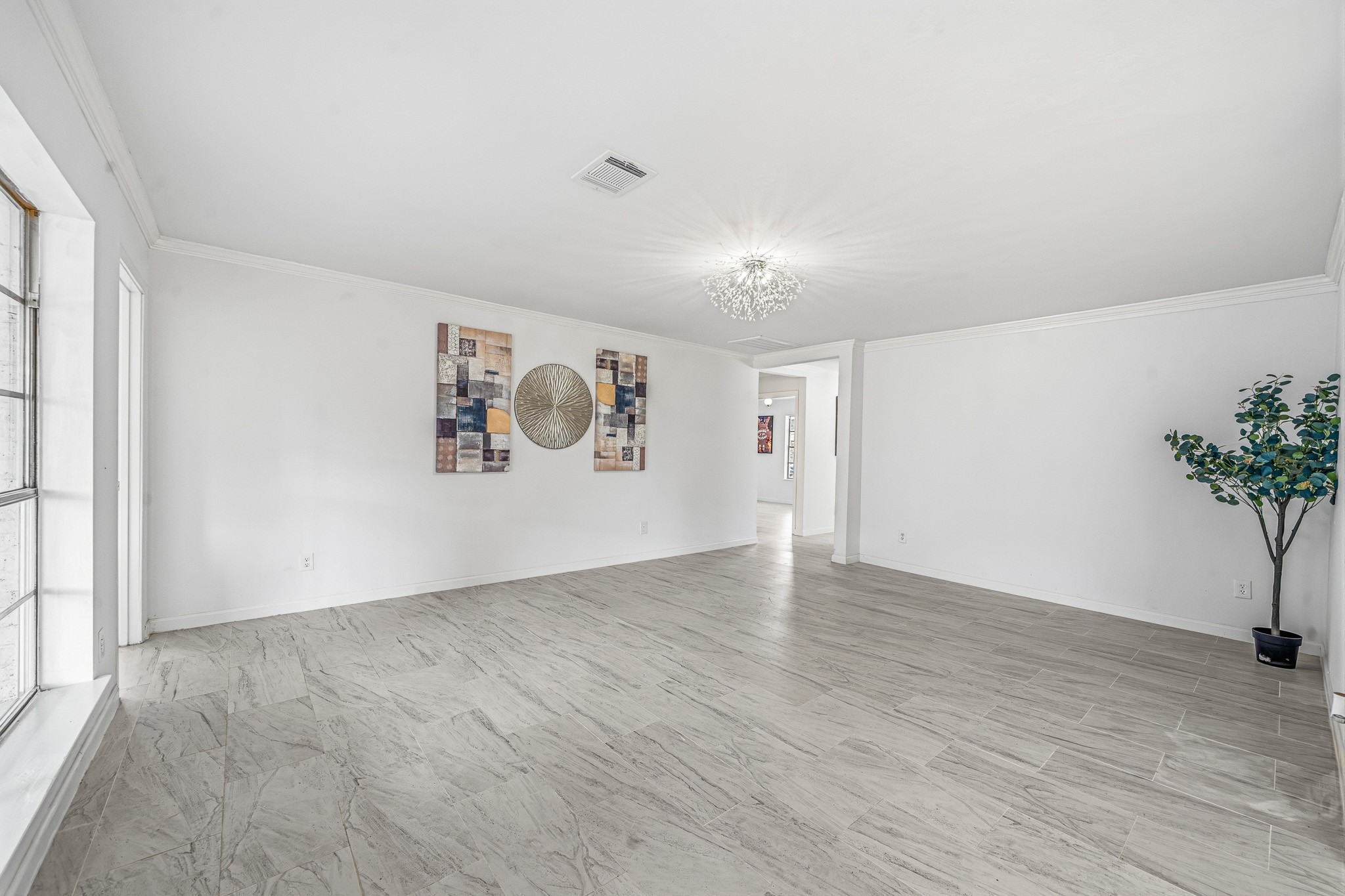 111 Princess Drive Houston, TX 77034 - Photo 14 of 30 an empty room with a potted plant and wooden floor
