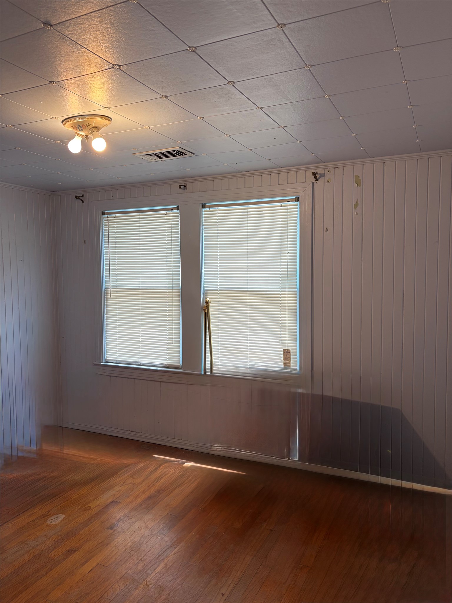817 South Main Street Highlands, TX 77562 - Photo 8 of 17 an empty room with wooden floor and windows