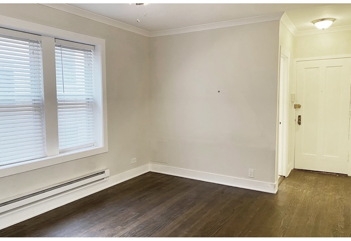4218 North Clark Street, Unit 2 Chicago, IL 60613 - Photo 8 of 12 a view of an empty room with wooden floor and a window