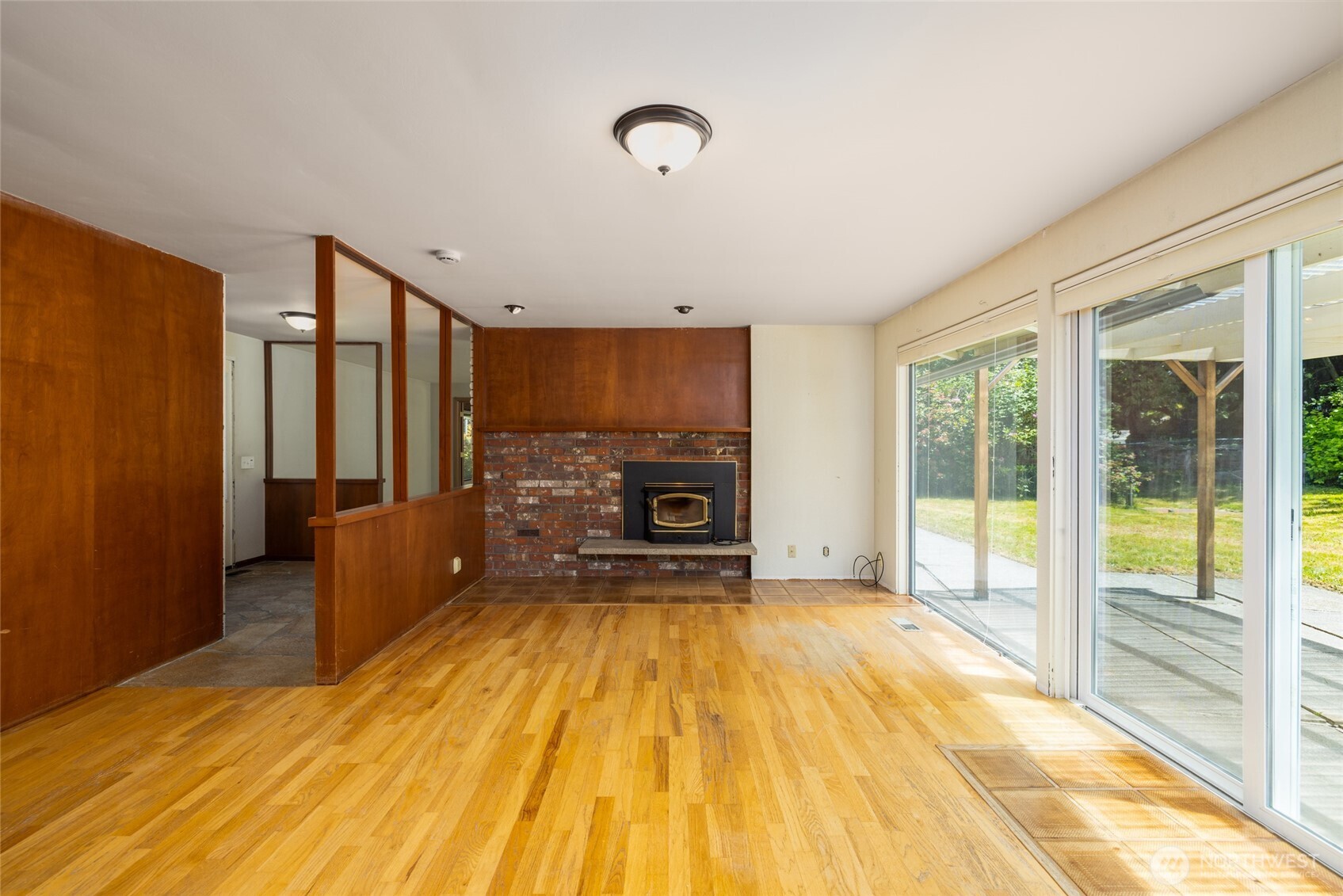 21316 Rolling Ridge Drive Sedro-Woolley, WA 98284 - Photo 6 of 37 a view of a livingroom with a fireplace a ceiling fan and wooden floor