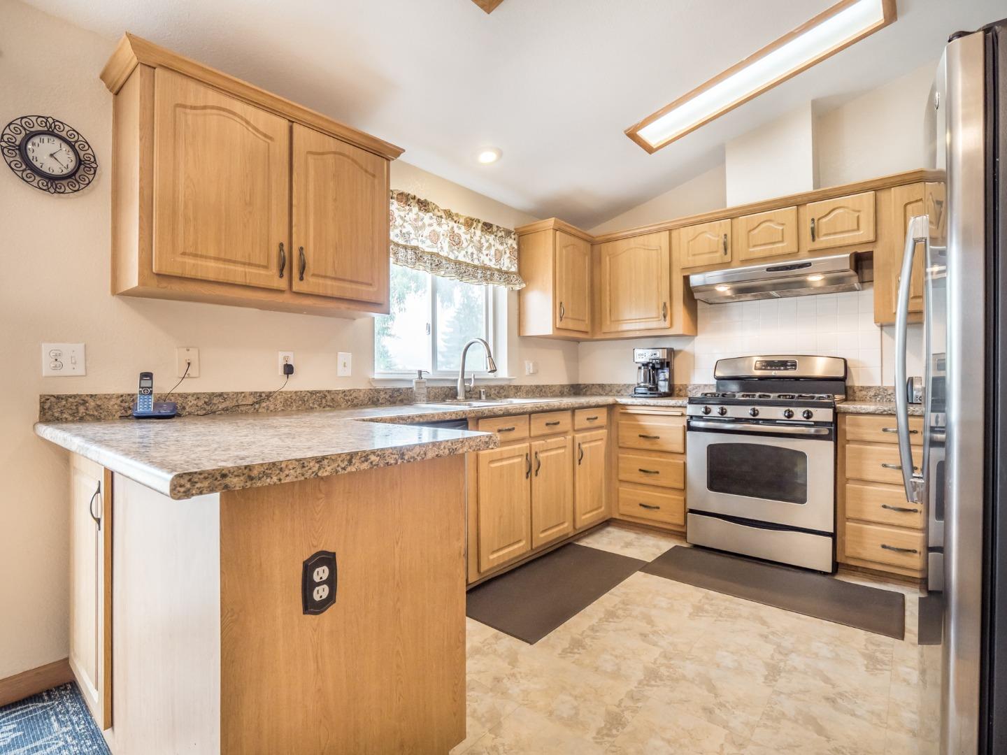 9 Dick Phelps Road Watsonville, CA 95076 - Photo 13 of 32 a kitchen with granite countertop a stove sink and cabinets