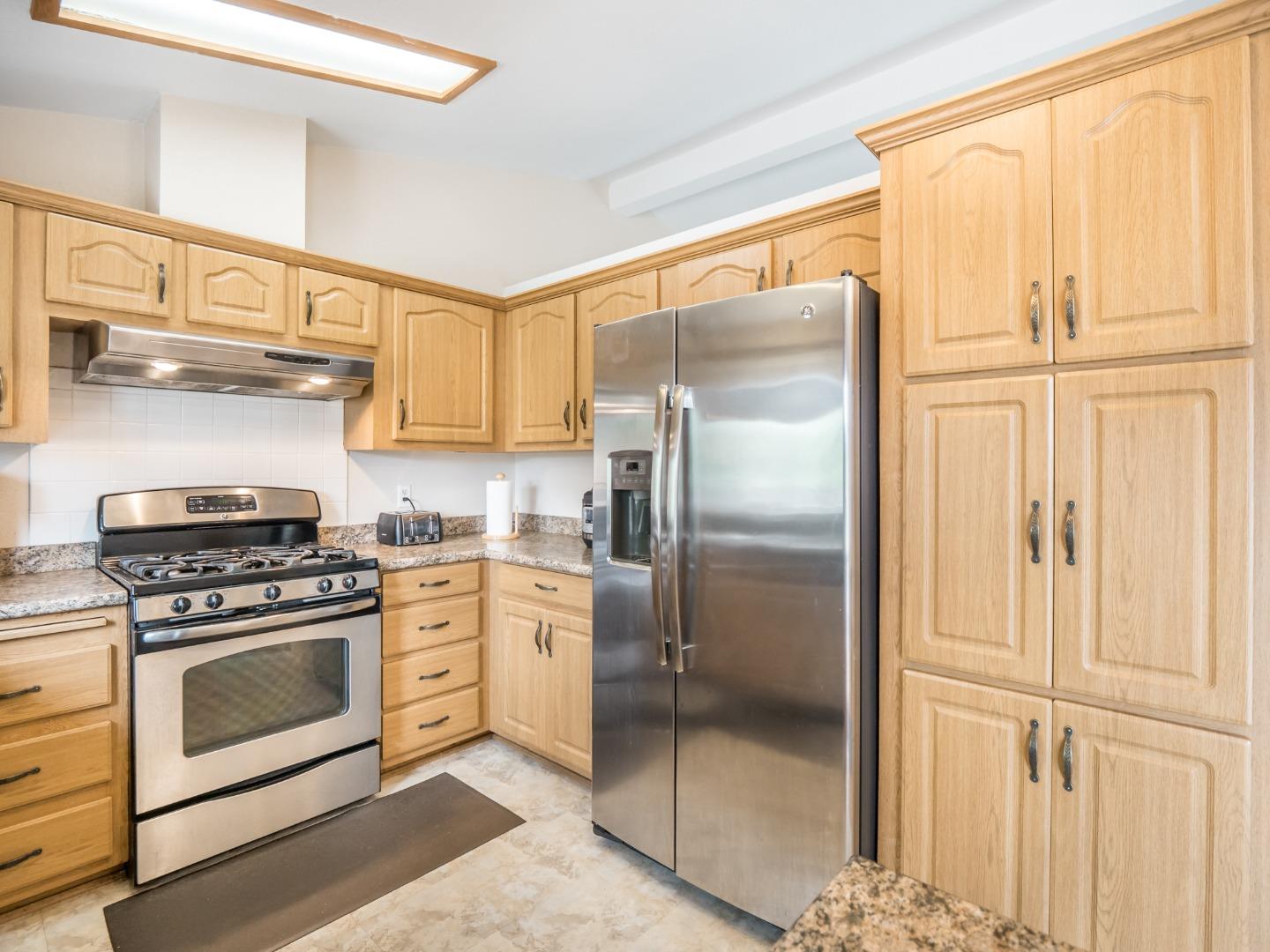 9 Dick Phelps Road Watsonville, CA 95076 - Photo 14 of 32 a kitchen with stainless steel appliances granite countertop a refrigerator and a stove