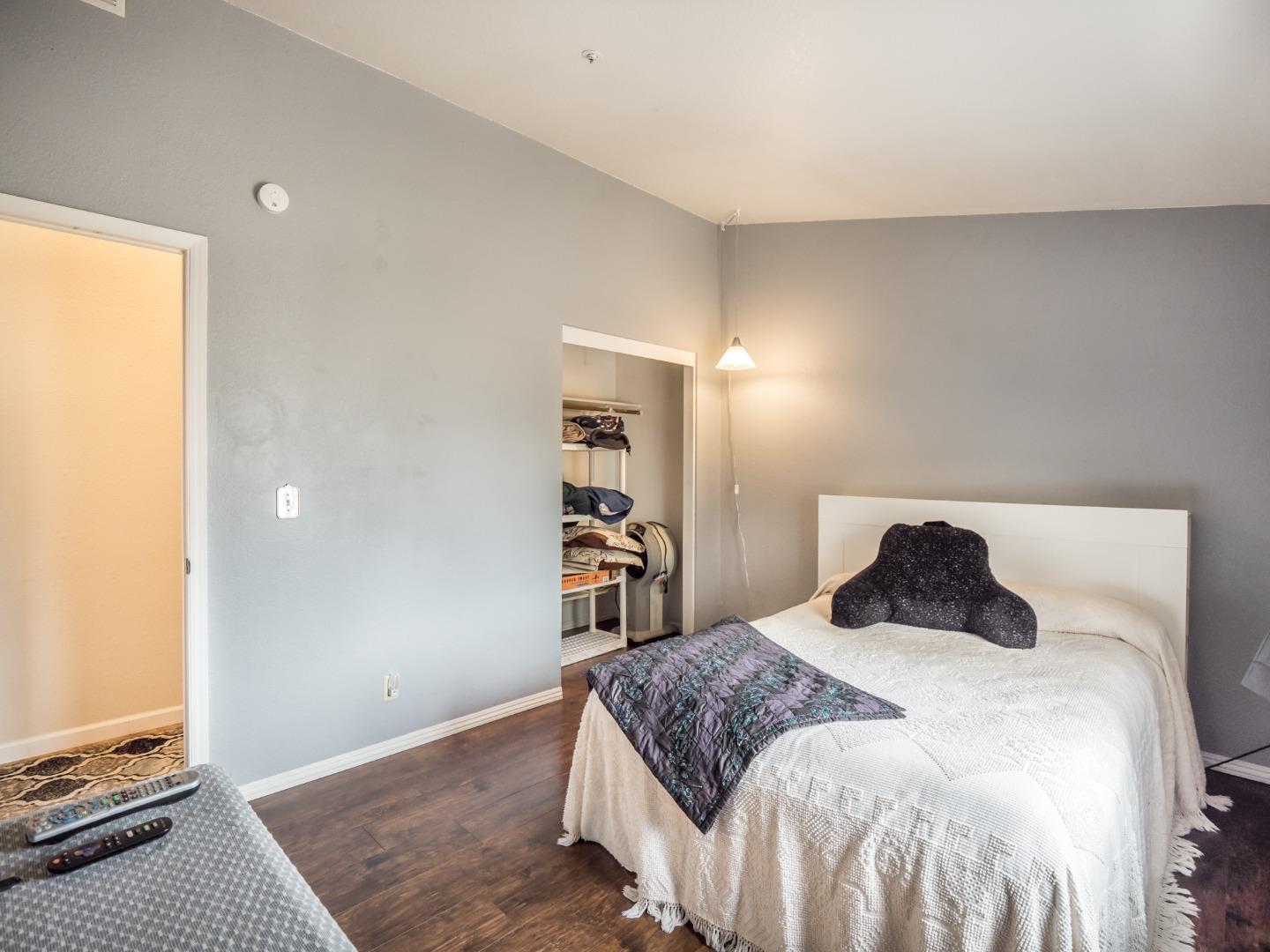 9 Dick Phelps Road Watsonville, CA 95076 - Photo 19 of 32 a bedroom with a bed and wooden floor