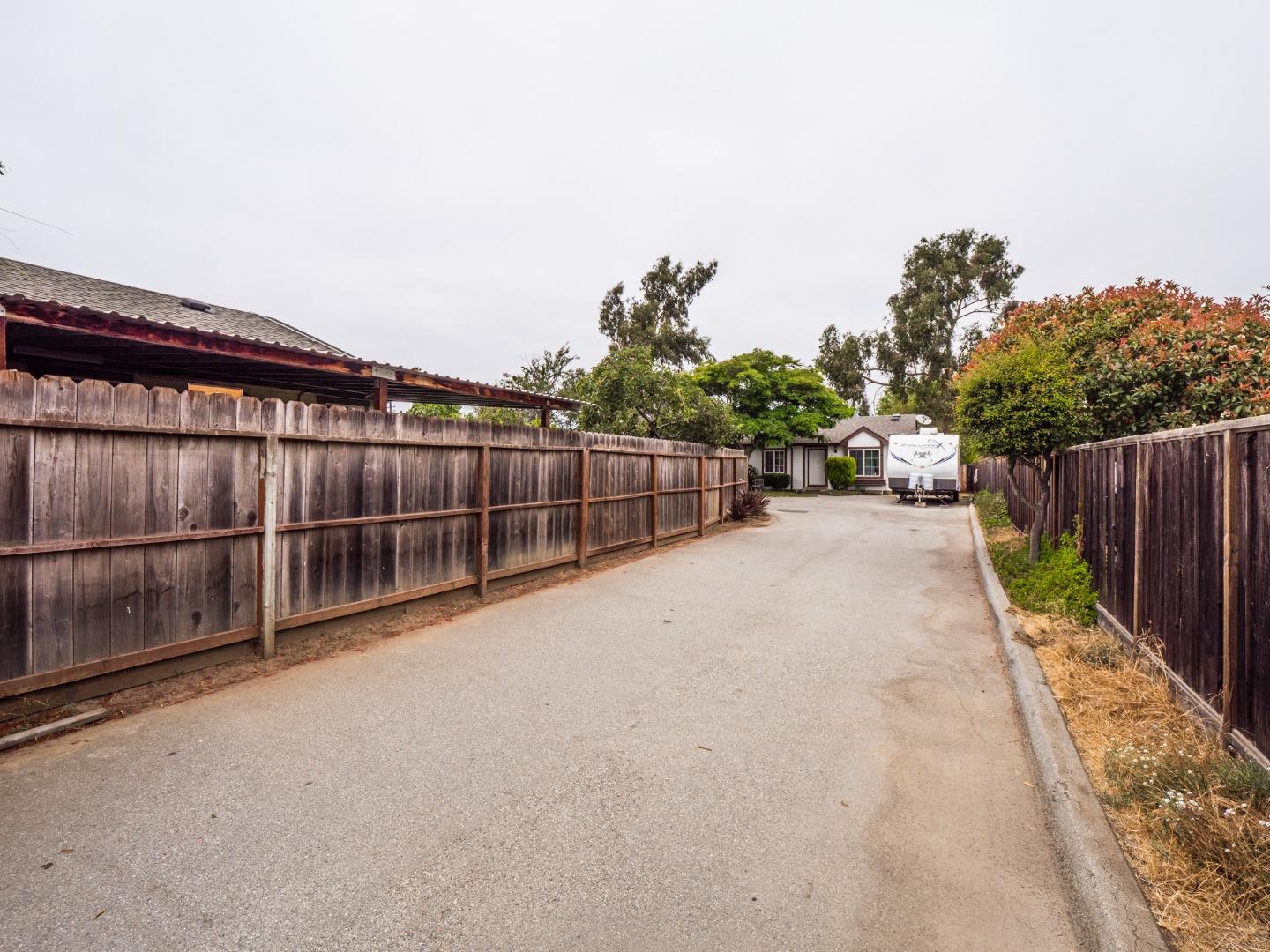 9 Dick Phelps Road Watsonville, CA 95076 - Photo 3 of 32 a view of a backyard with wooden fence