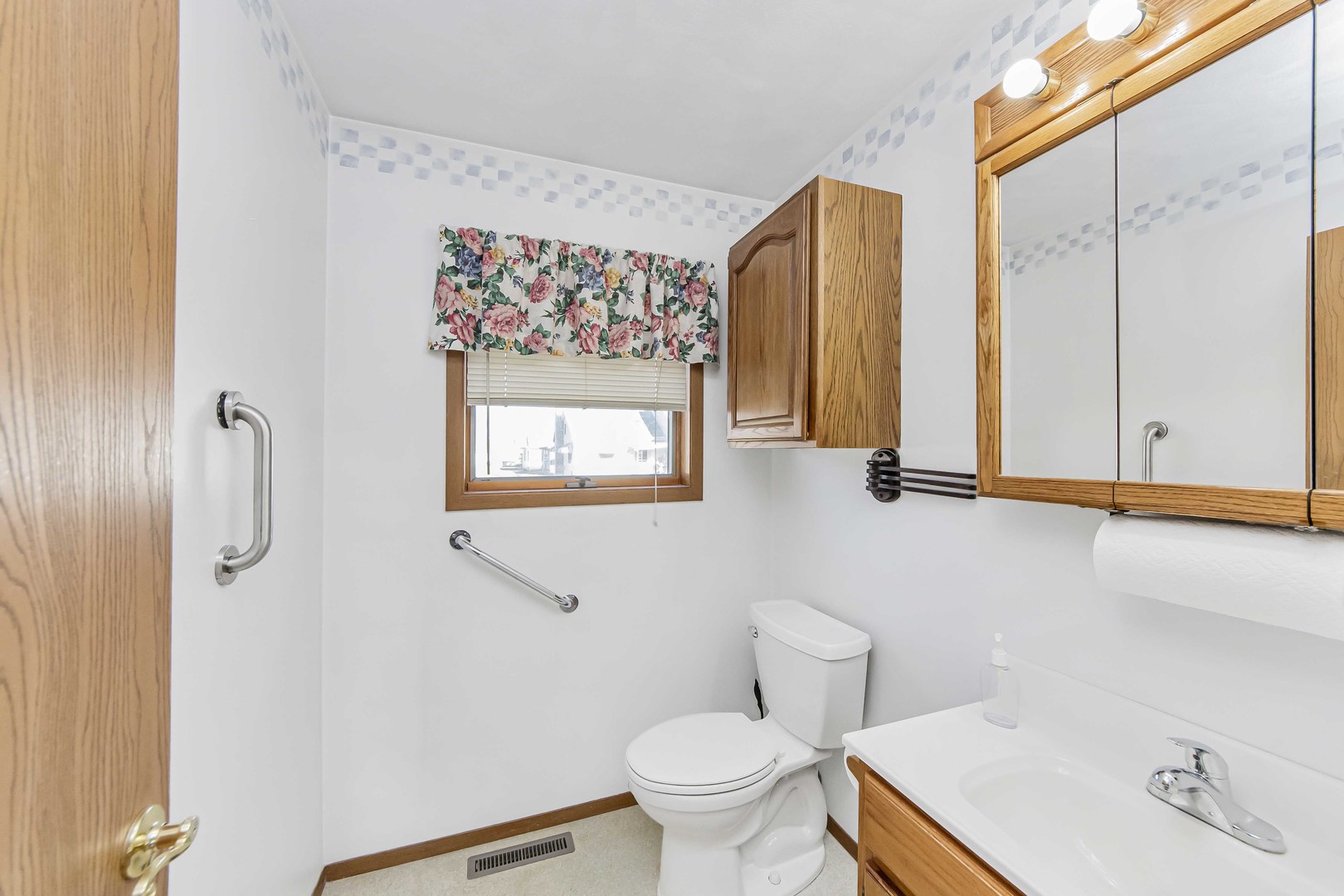 313 West Topeka Street Toluca, IL 61369 - Photo 19 of 32 a bathroom with a toilet sink and mirror