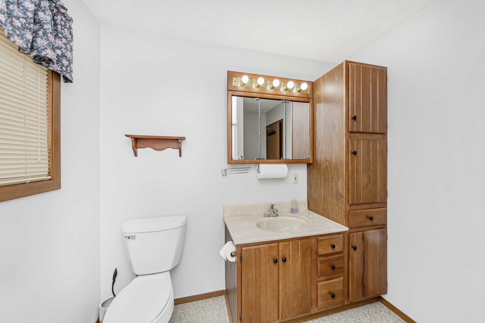 313 West Topeka Street Toluca, IL 61369 - Photo 22 of 32 a bathroom with a sink a toilet and mirror