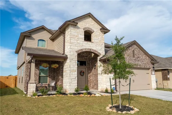 a front view of a house with garden