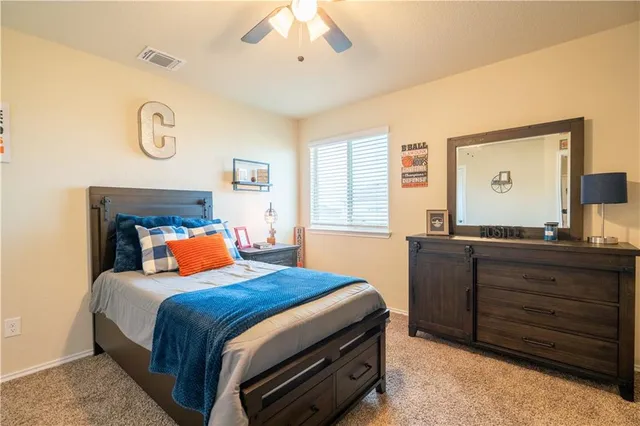 a bedroom with a bed and a bookshelf