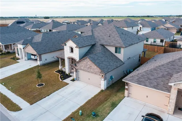 an aerial view of residential houses with outdoor space
