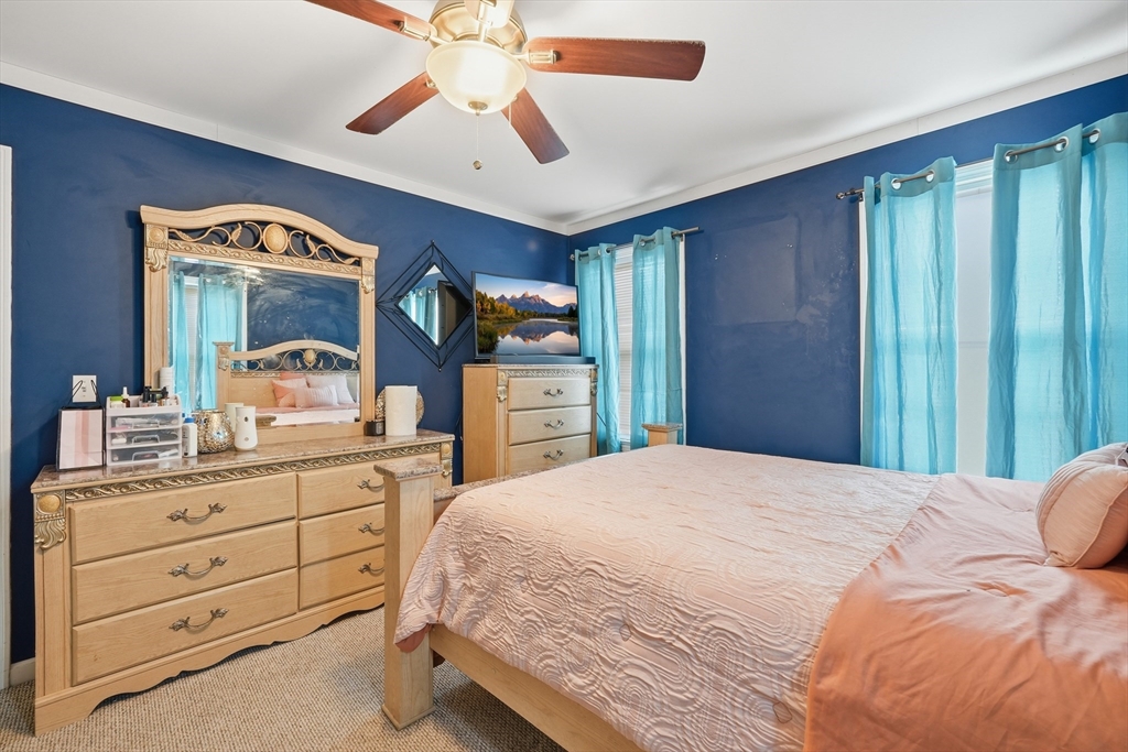 19 Annies Way Springfield, MA 01119 - Photo 23 of 40 a bedroom with a bed and a chandelier