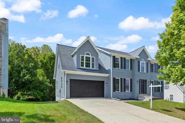 a front view of a house with a garden and yard
