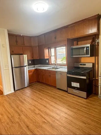 a kitchen with granite countertop stainless steel appliances and wooden cabinets