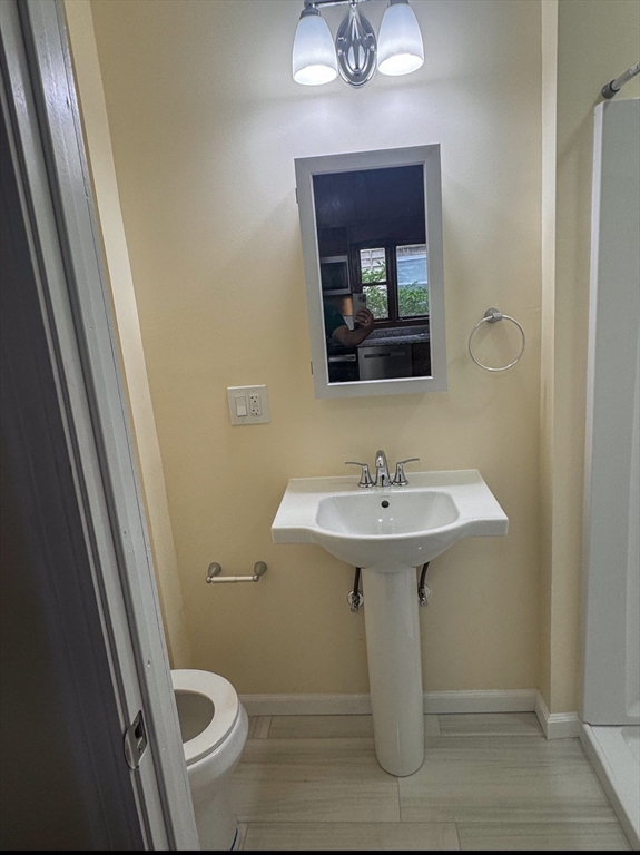 35 Hollander Street, Unit 2 Boston, MA 02121 - Photo 13 of 17 a bathroom with a sink toilet and mirror