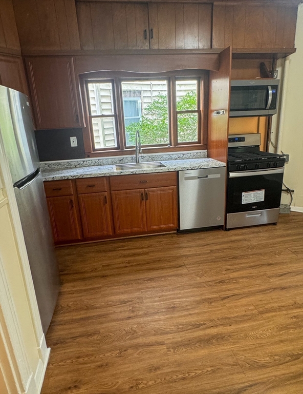 35 Hollander Street, Unit 2 Boston, MA 02121 - Photo 10 of 17 a view of a kitchen with wooden floor and electronic appliances