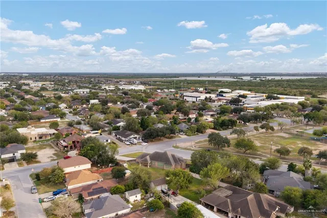 an aerial view of a house with a swimming pool yard and mountain view in back