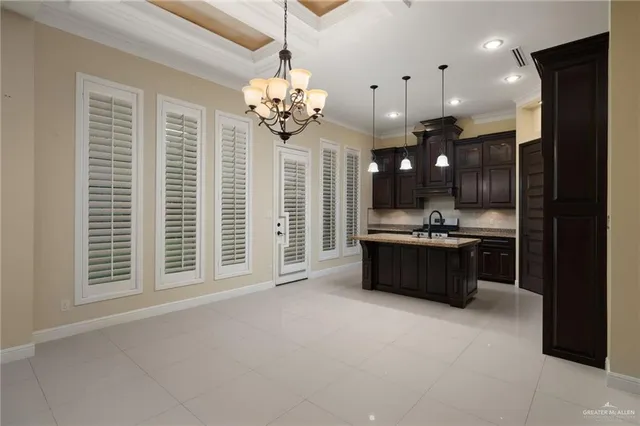 a large room with a large window and stainless steel appliances