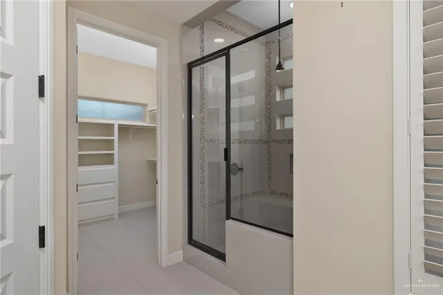 a bathroom with a glass shower door