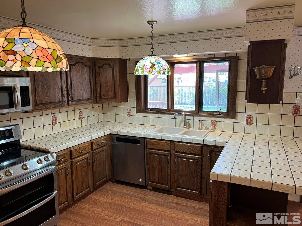 1840 Allen Street Reno, NV 89509 - Photo 6 of 20 a kitchen with a sink stove and microwave