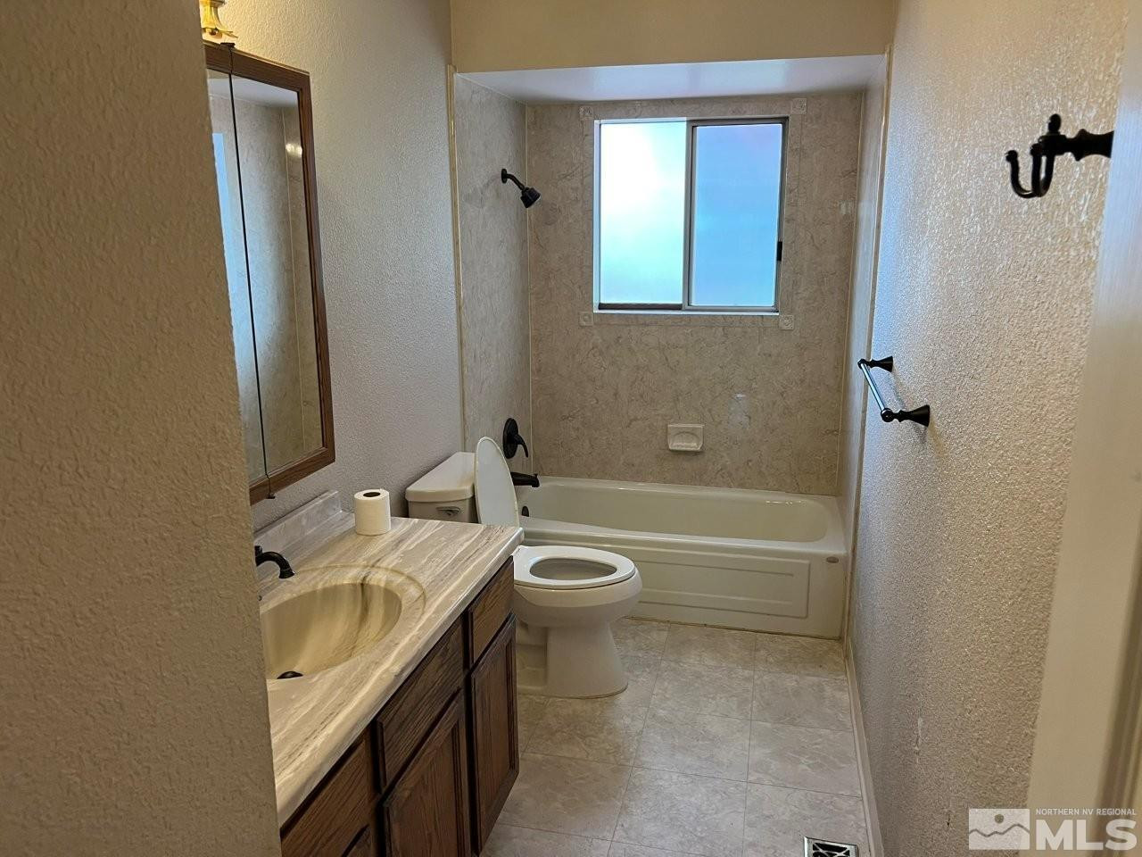 1840 Allen Street Reno, NV 89509 - Photo 10 of 20 a bathroom with a granite countertop toilet a sink and bathtub
