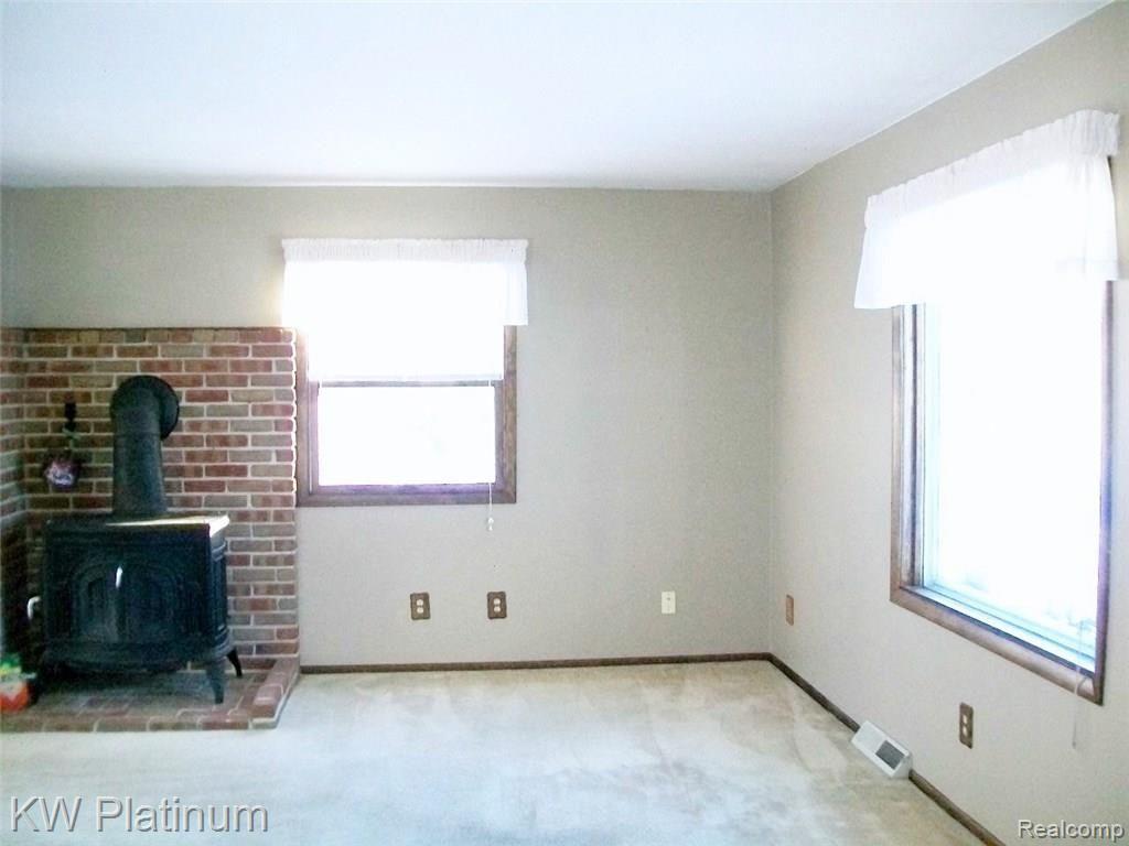 7880 Graham Road Jeddo, MI 48032 - Photo 5 of 14 Cozy warm and well lit living room includes natural wood stove.