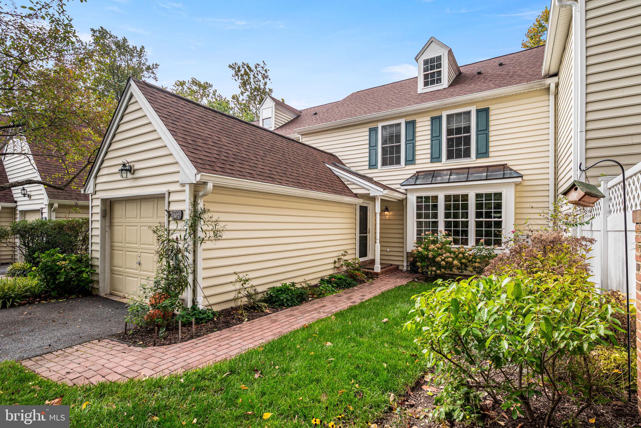 102 Dundee Mills Lane Wallingford, PA 19086 - Photo 2 of 43 a front view of a house with garden