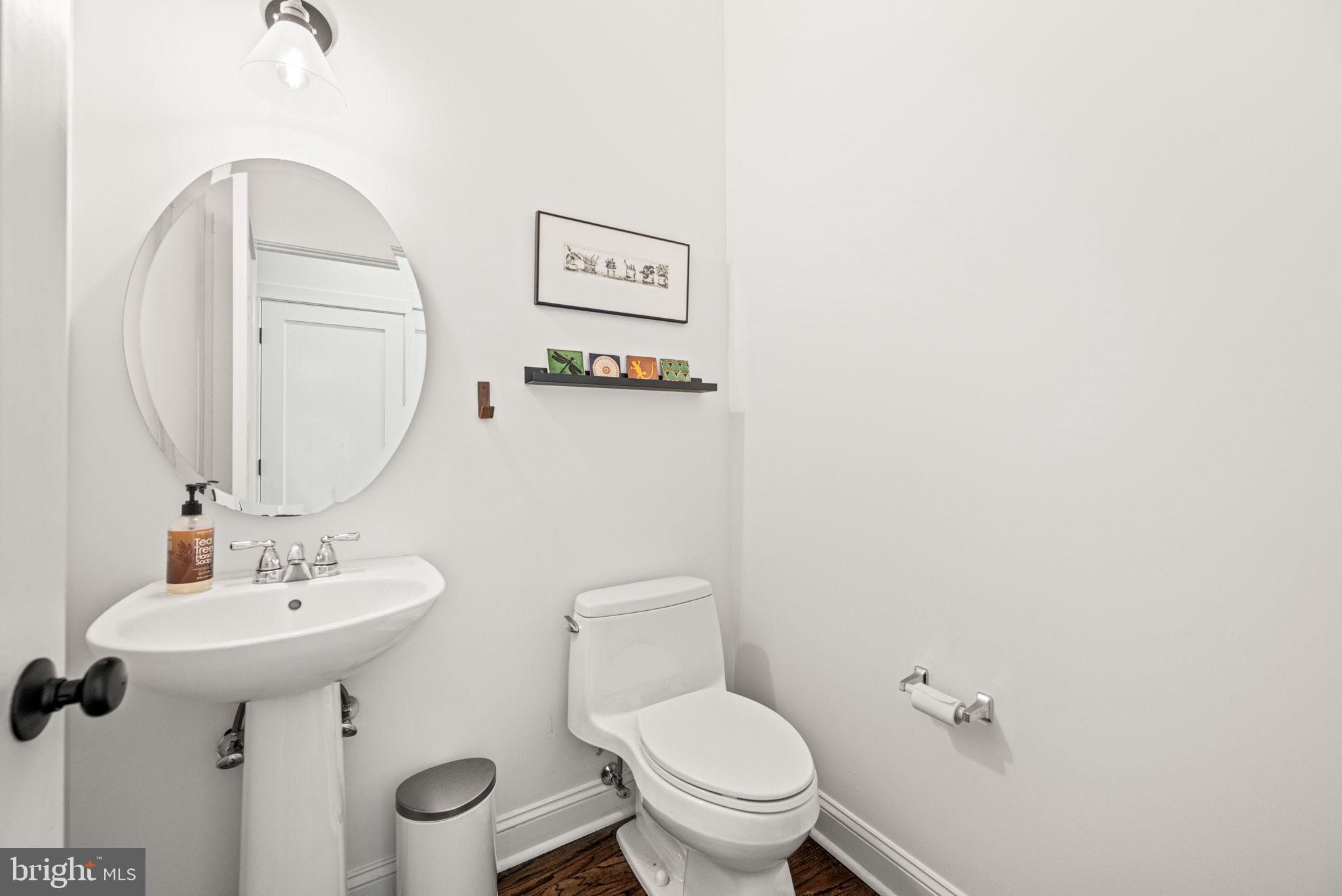 102 Dundee Mills Lane Wallingford, PA 19086 - Photo 21 of 43 a bathroom with a toilet sink and mirror