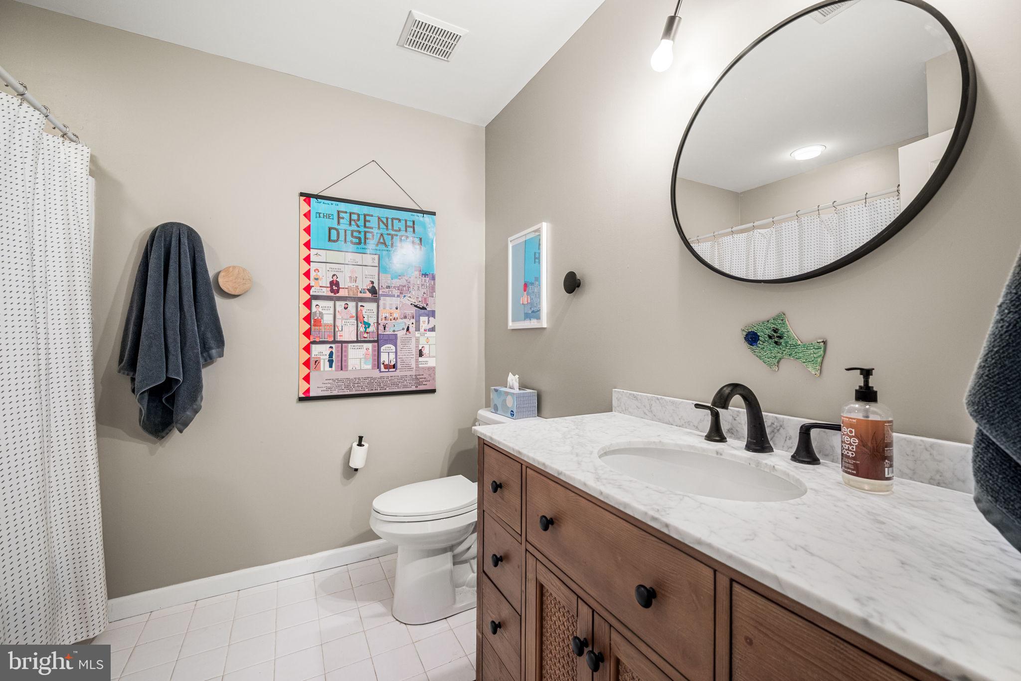 102 Dundee Mills Lane Wallingford, PA 19086 - Photo 31 of 43 a bathroom with a toilet sink and mirror