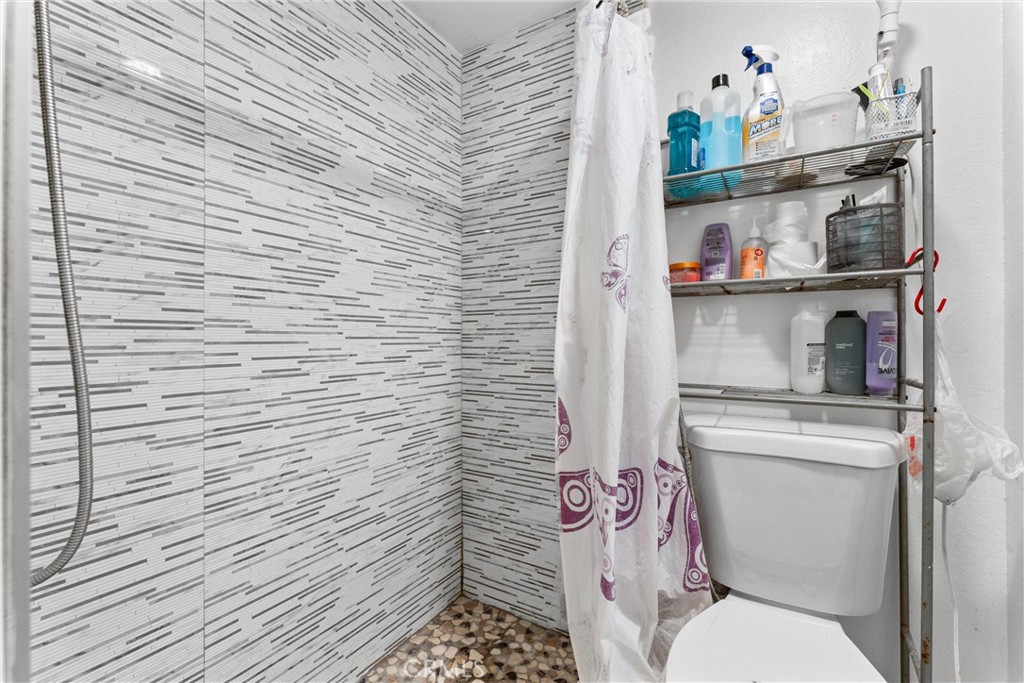 3927 West McFadden Avenue, Unit B Santa Ana, CA 92704 - Photo 7 of 14 a bathroom with a toilet and a sink