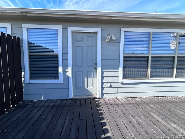 a view of a house with a door and wooden floor