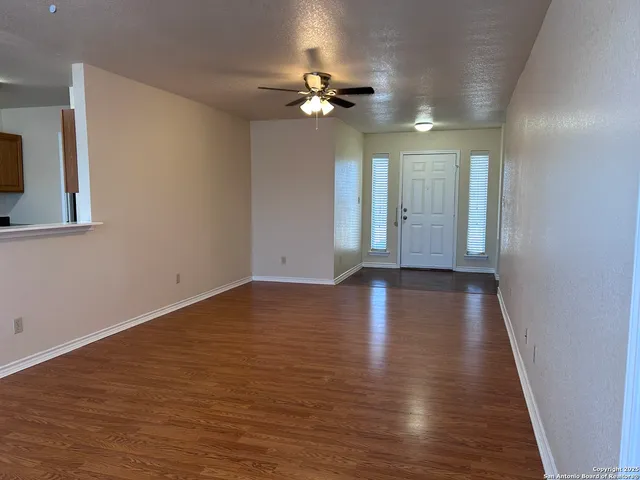 wooden floor in an empty room with a window