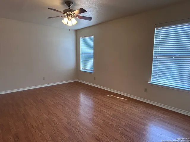 a view of a room with wooden floor and a window