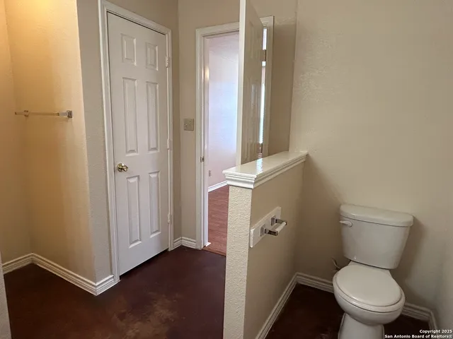 a white toilet sitting next to a bathroom sink
