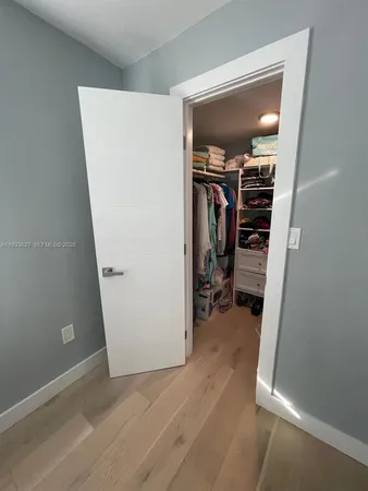a utility room with dryer washer and a view of living room