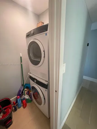 a bathroom with a sink and mirror with bathtub