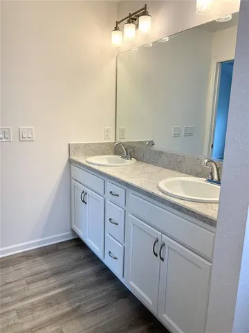 a bathroom with a granite countertop sink and a mirror