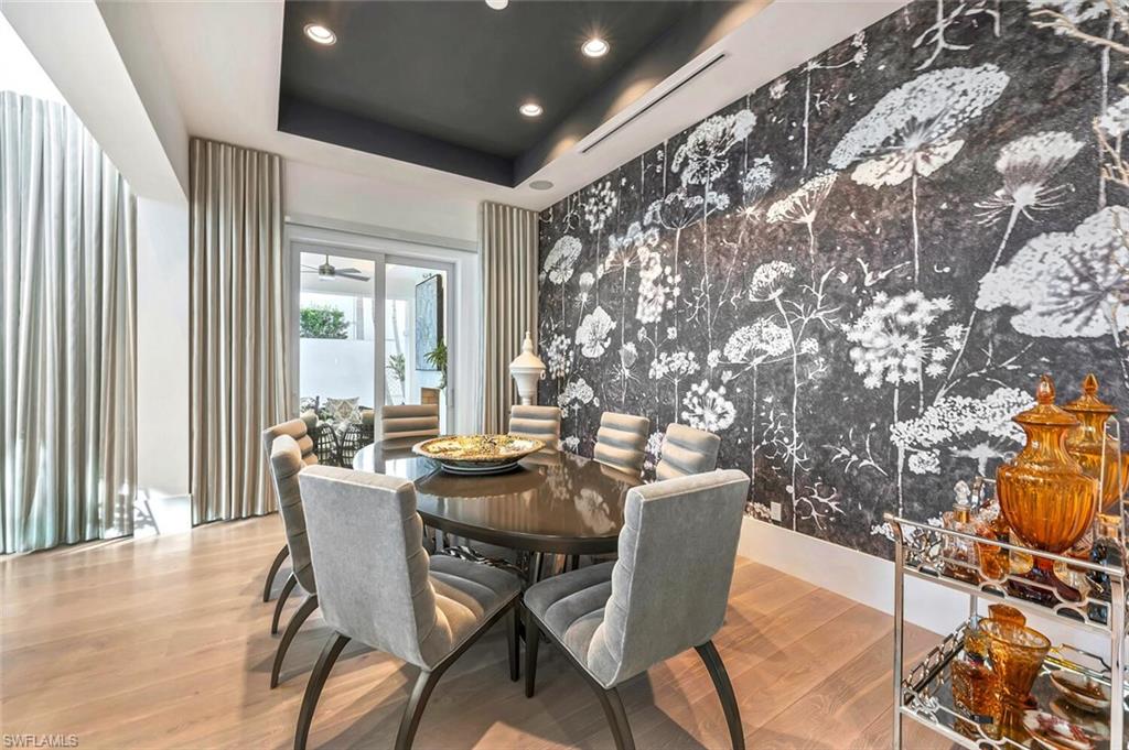 9193 Mercato Way Naples, FL 34108 - Photo 13 of 36 a dining room with furniture and wooden floor