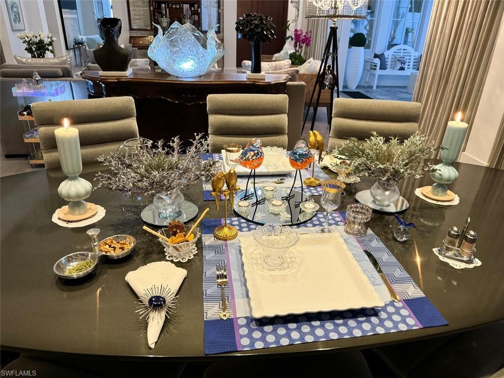 9193 Mercato Way Naples, FL 34108 - Photo 14 of 36 a living room with furniture and floor to ceiling windows