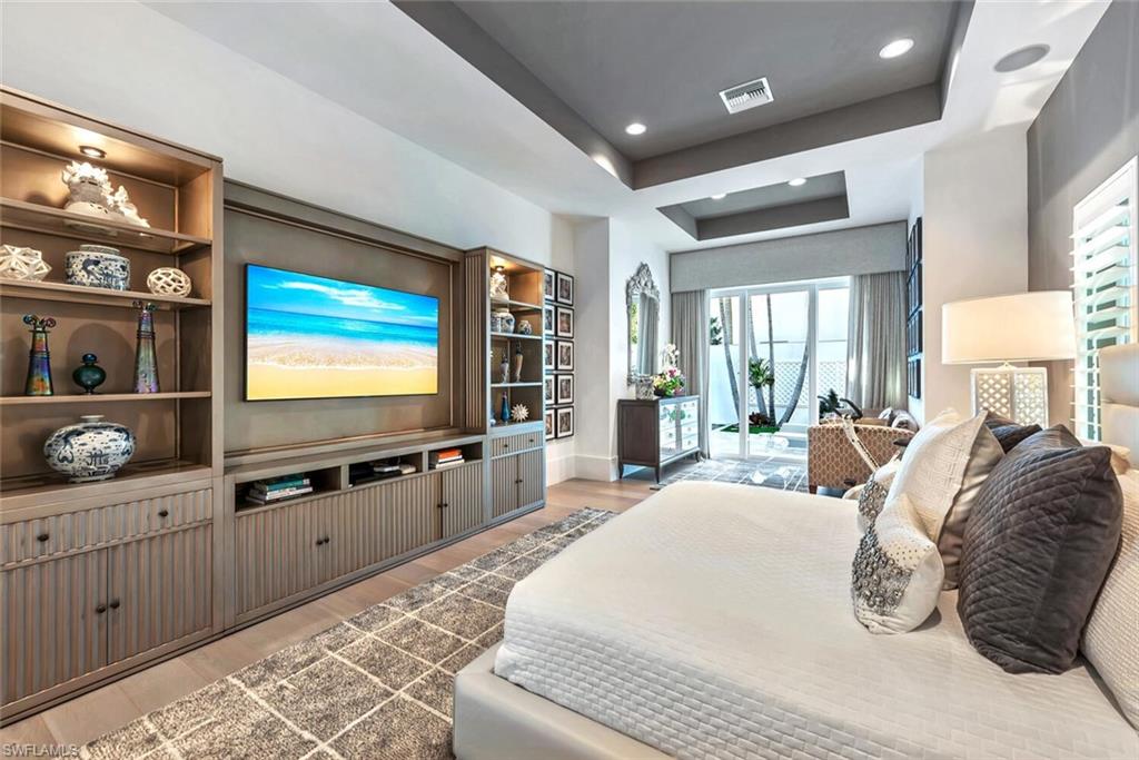 9193 Mercato Way Naples, FL 34108 - Photo 16 of 36 a bedroom with furniture and a flat screen tv