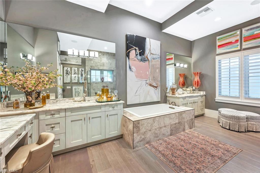 9193 Mercato Way Naples, FL 34108 - Photo 18 of 36 a spacious bathroom with a tub sink and mirror