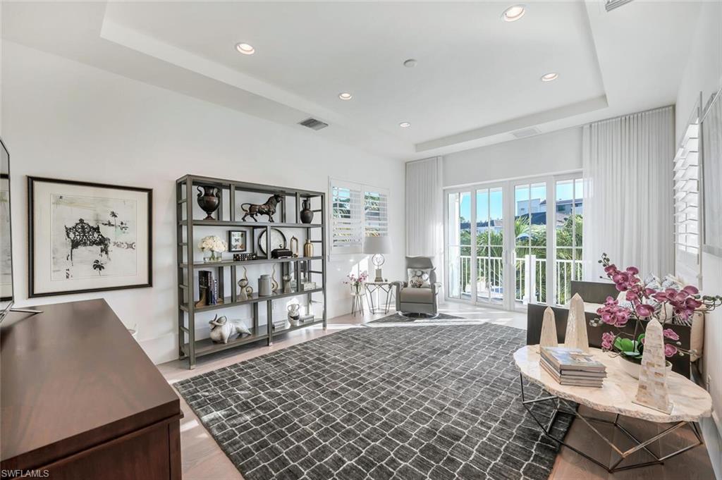 9193 Mercato Way Naples, FL 34108 - Photo 28 of 36 a living room with furniture a rug and a large window