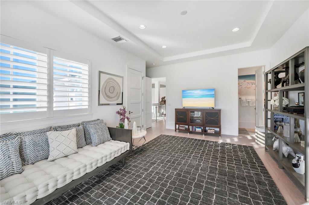 9193 Mercato Way Naples, FL 34108 - Photo 29 of 36 a living room with furniture and a fireplace