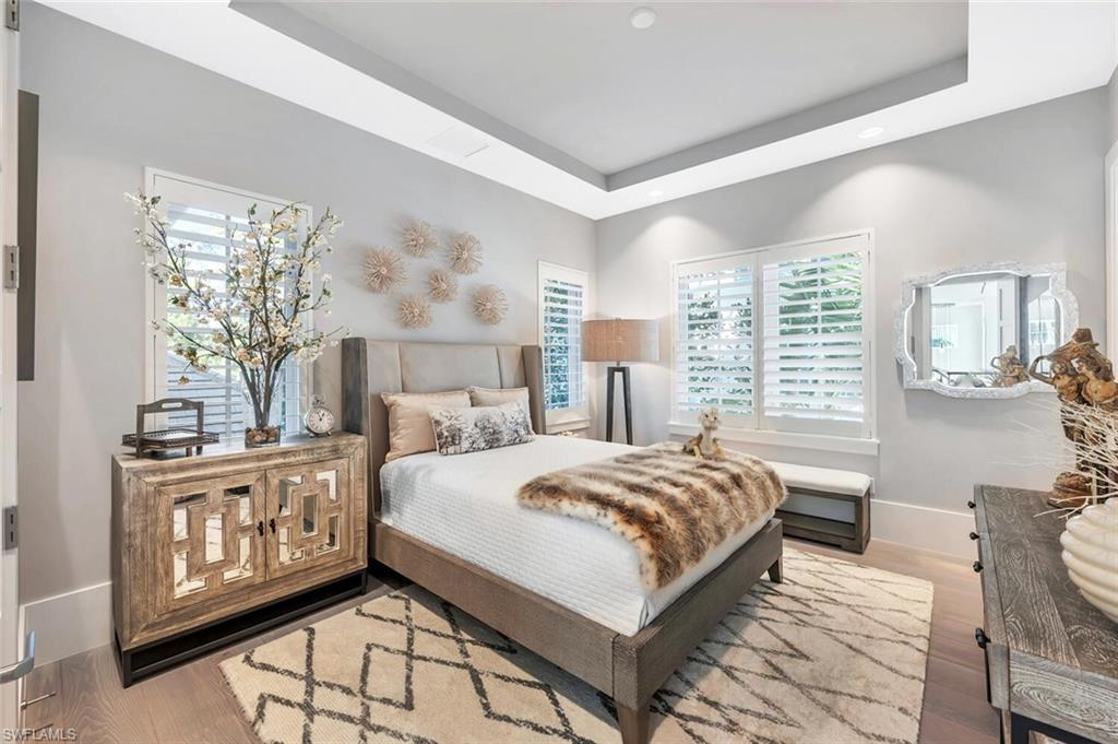 9193 Mercato Way Naples, FL 34108 - Photo 31 of 36 a bedroom with a large bed and a window