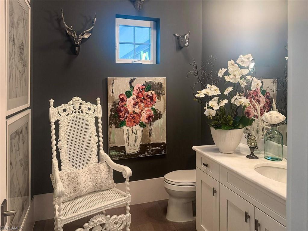 9193 Mercato Way Naples, FL 34108 - Photo 10 of 36 a bathroom with a toilet sink vanity granite and mirror